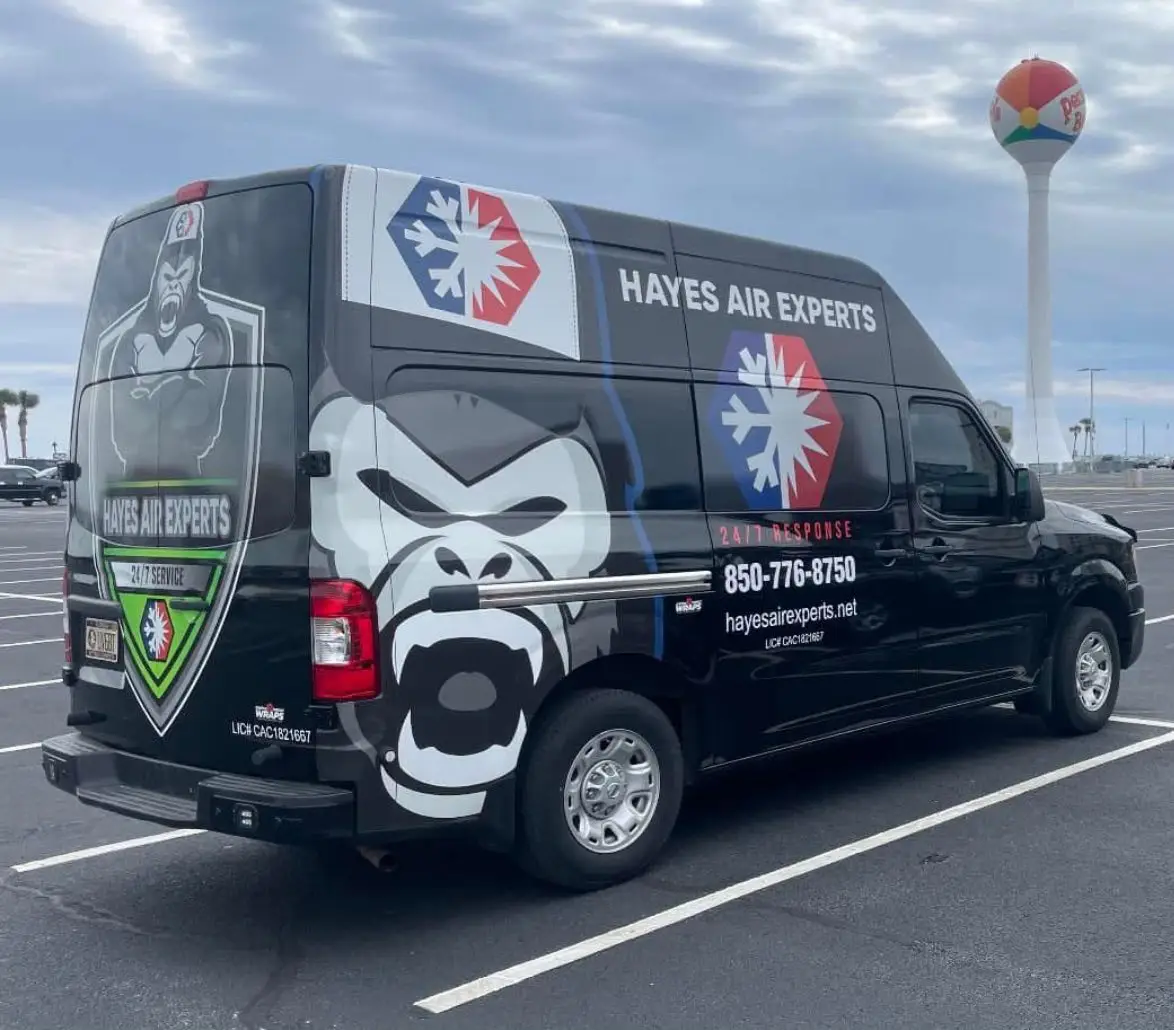 Black Hayes Air Experts service van with gorilla graphic and snowflake logo parked in a parking lot