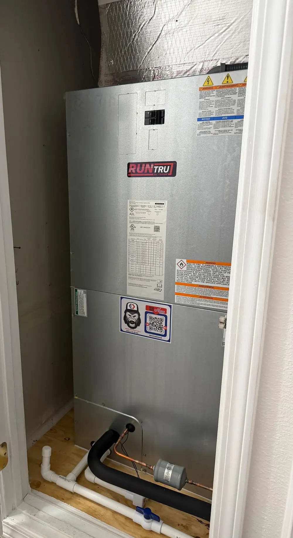 RunTru air handler inside closet with insulated refrigerant lines, condensate PVC drain and copper piping